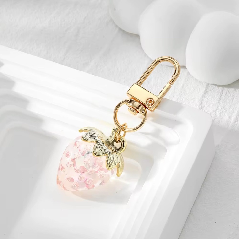 1 Pink strawberry keychain and 1 lip oil plumper